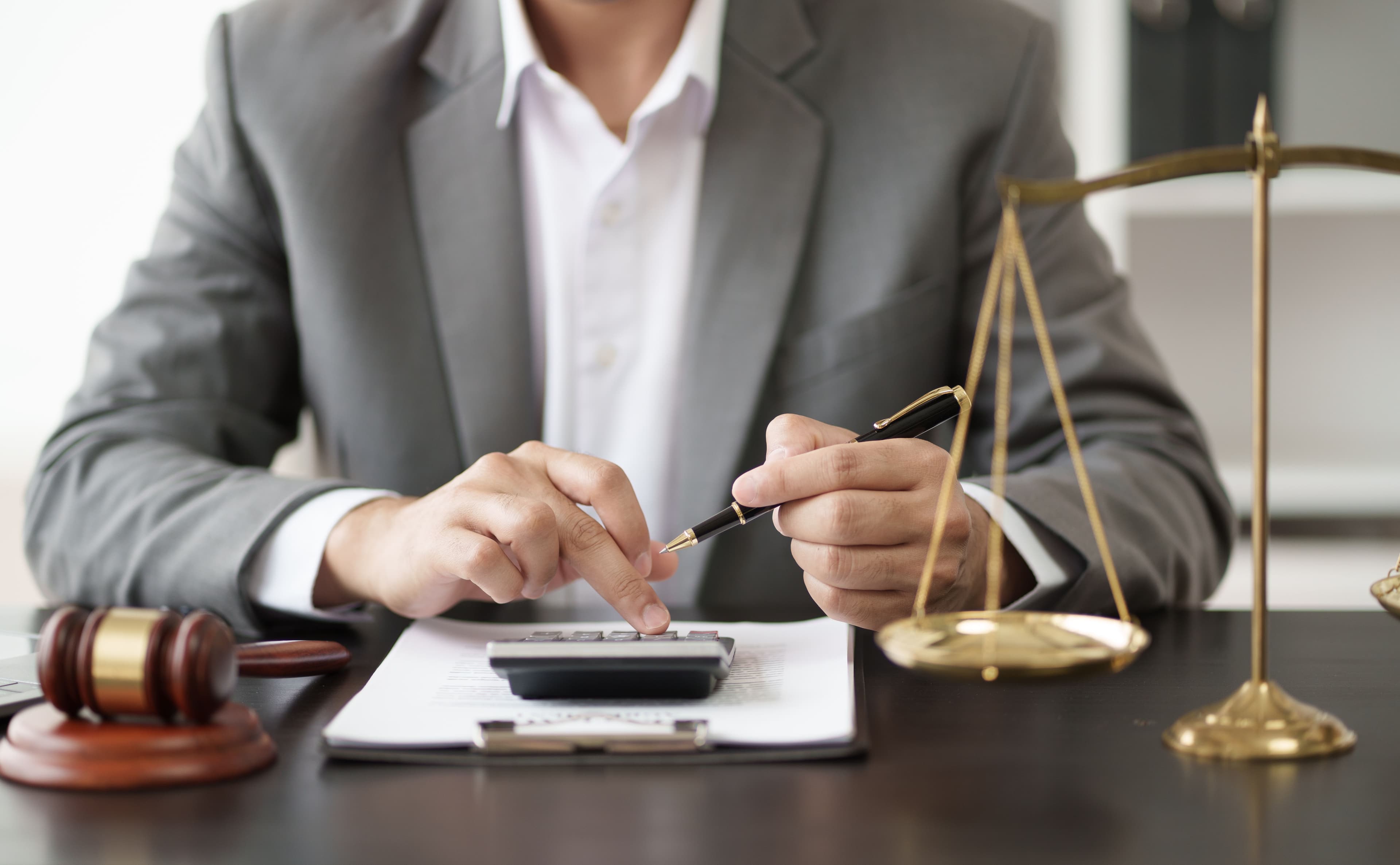 A lawyer calculating his client's potential compensation for a personal injury case. 