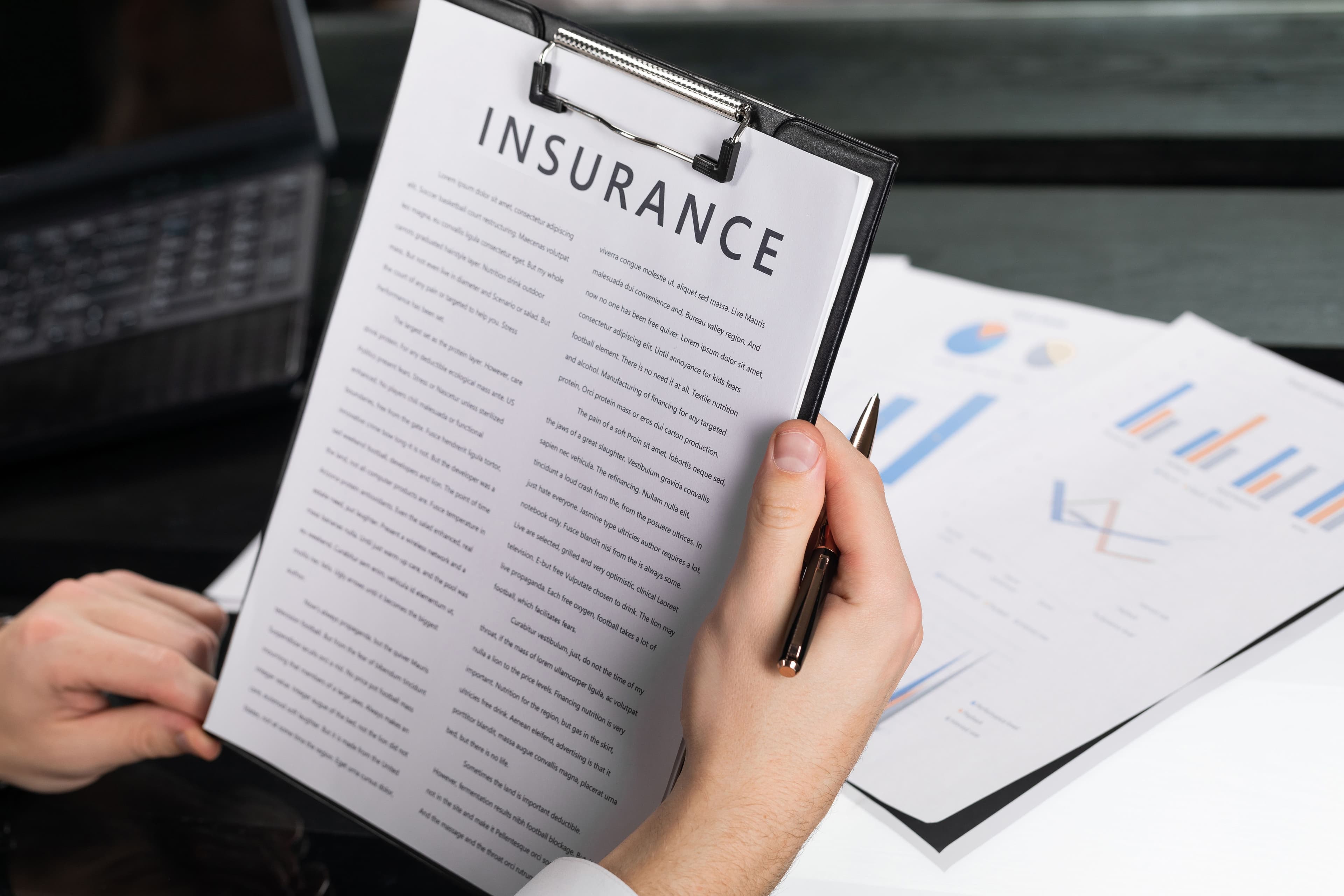 Someone applying the fundamentals of insurance to carefully read through their policy. 