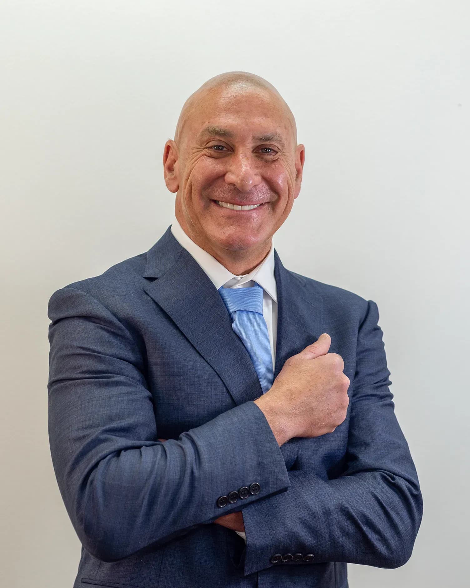 Personal injury attorney Scott Senft smiling with arms crossed.