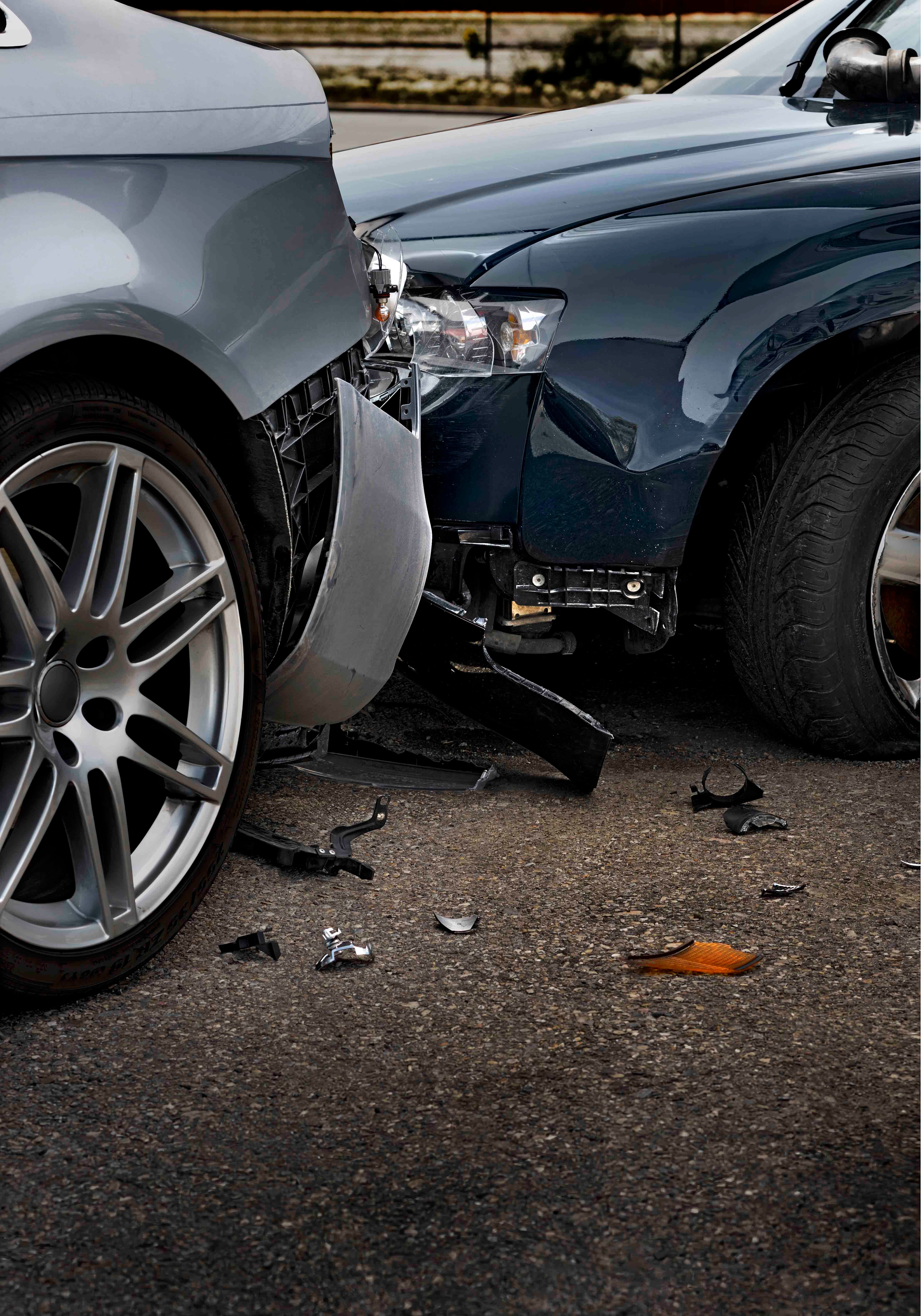 Two damaged vehicles in the aftermath of a car accident.
